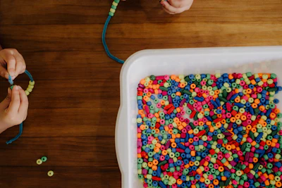 A child playing with beads on a table