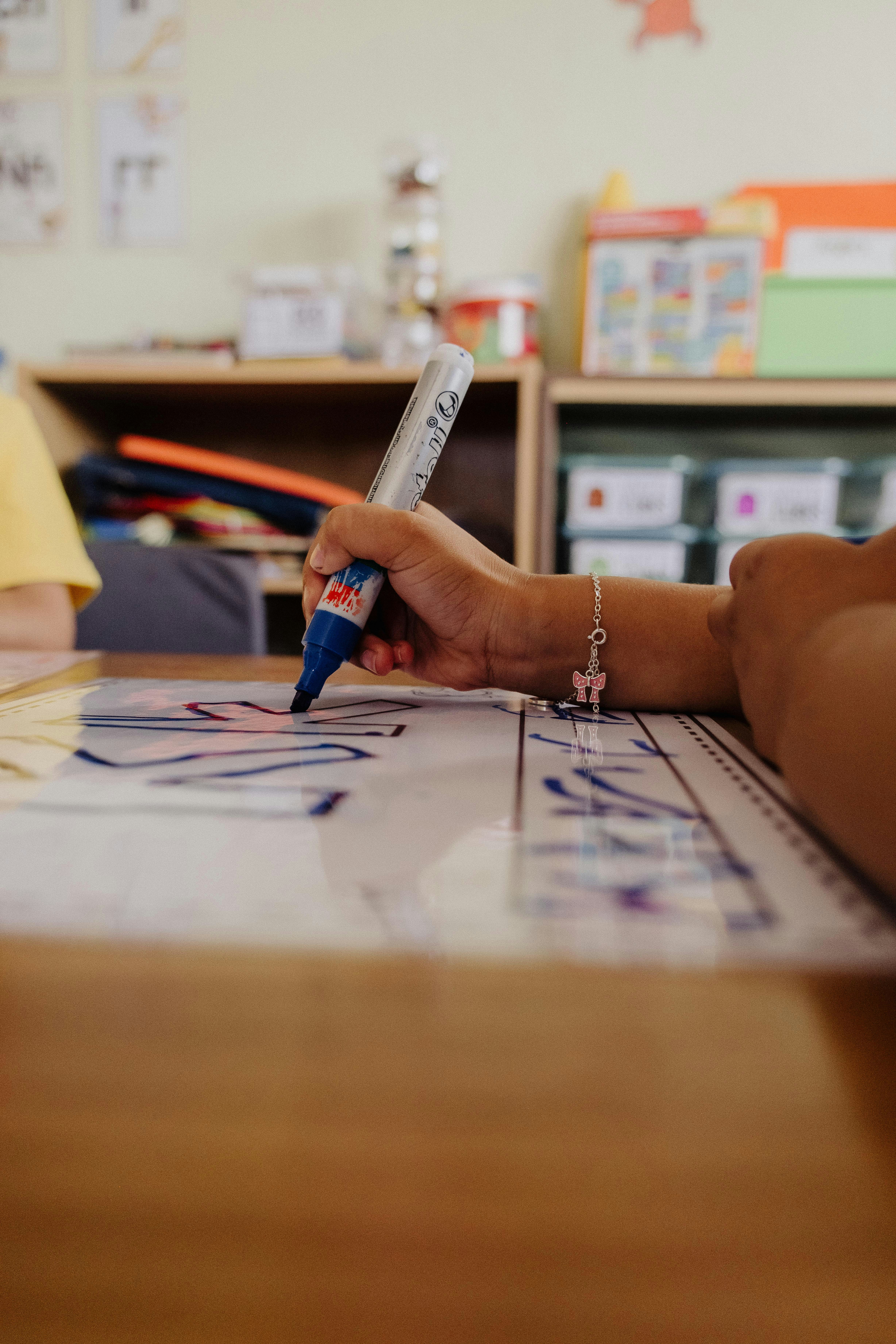 A child is drawing on a large piece of paper