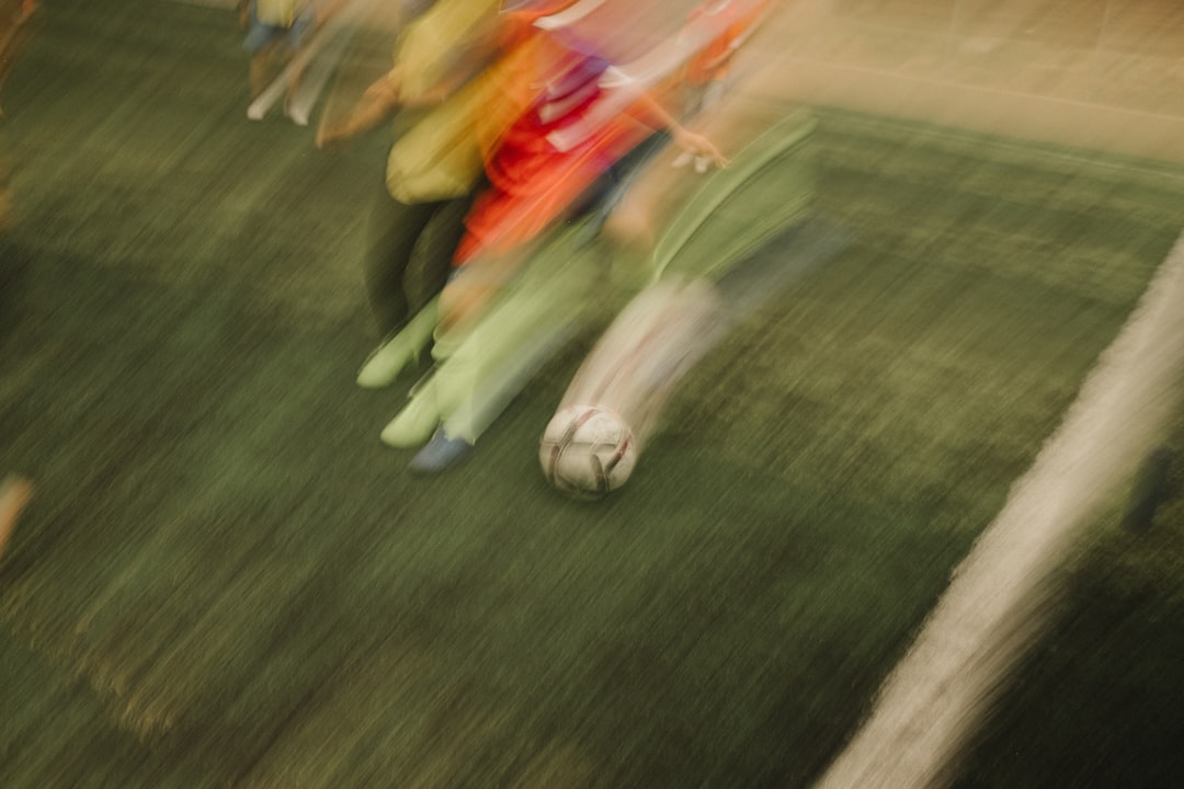 A blurry photo of a group of people playing soccer