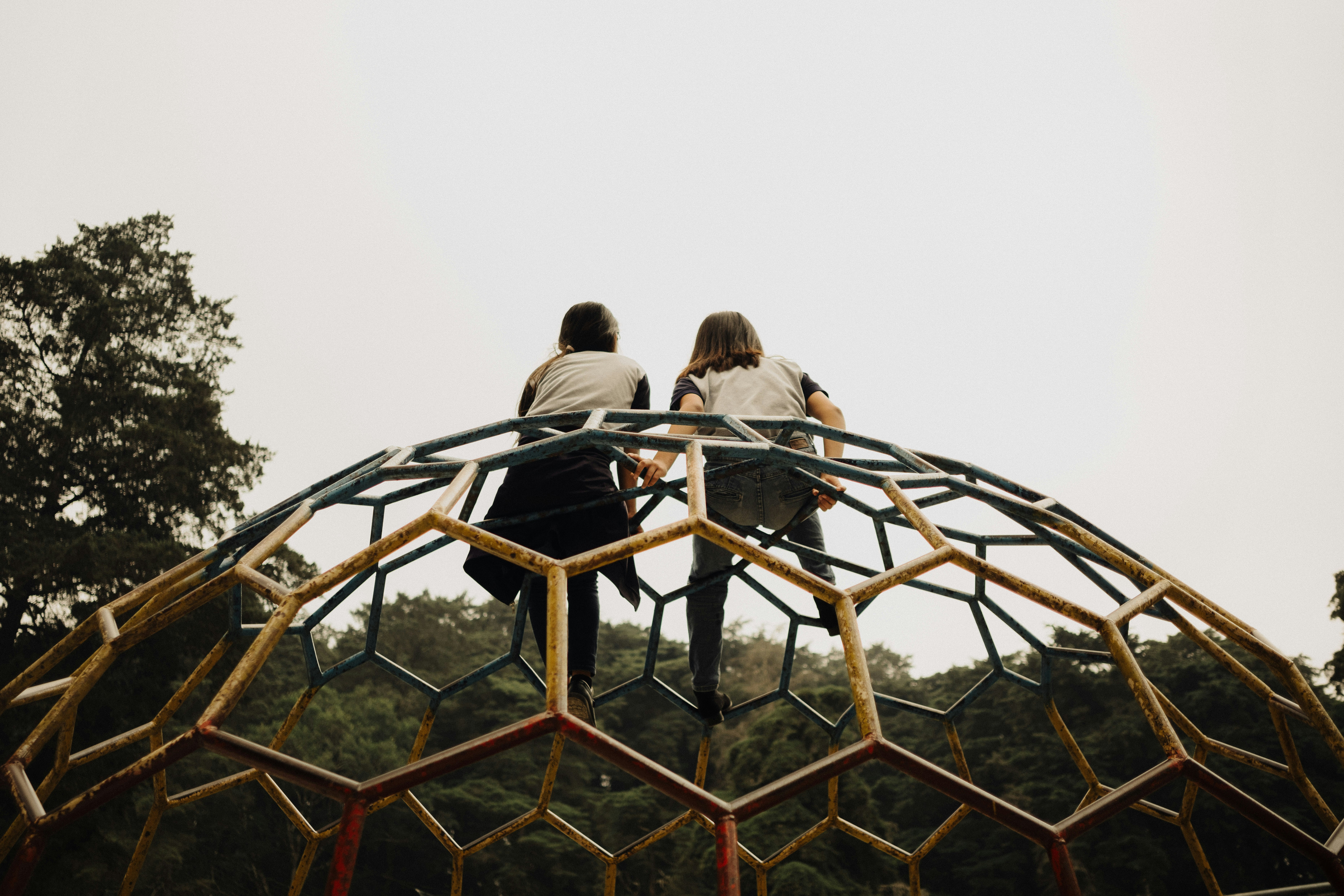 A couple of people standing on top of a metal structure