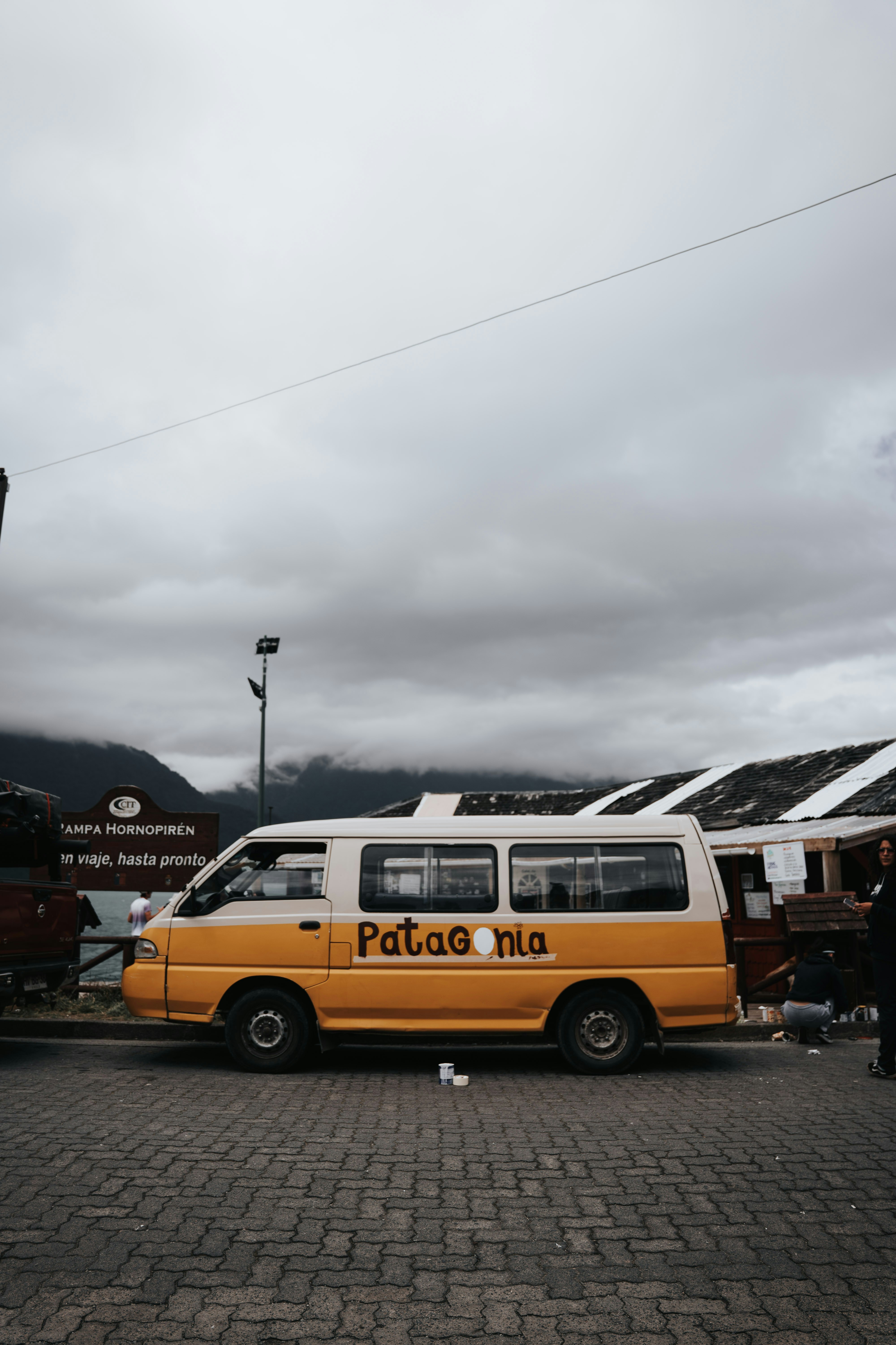 A yellow and white van parked in a parking lot