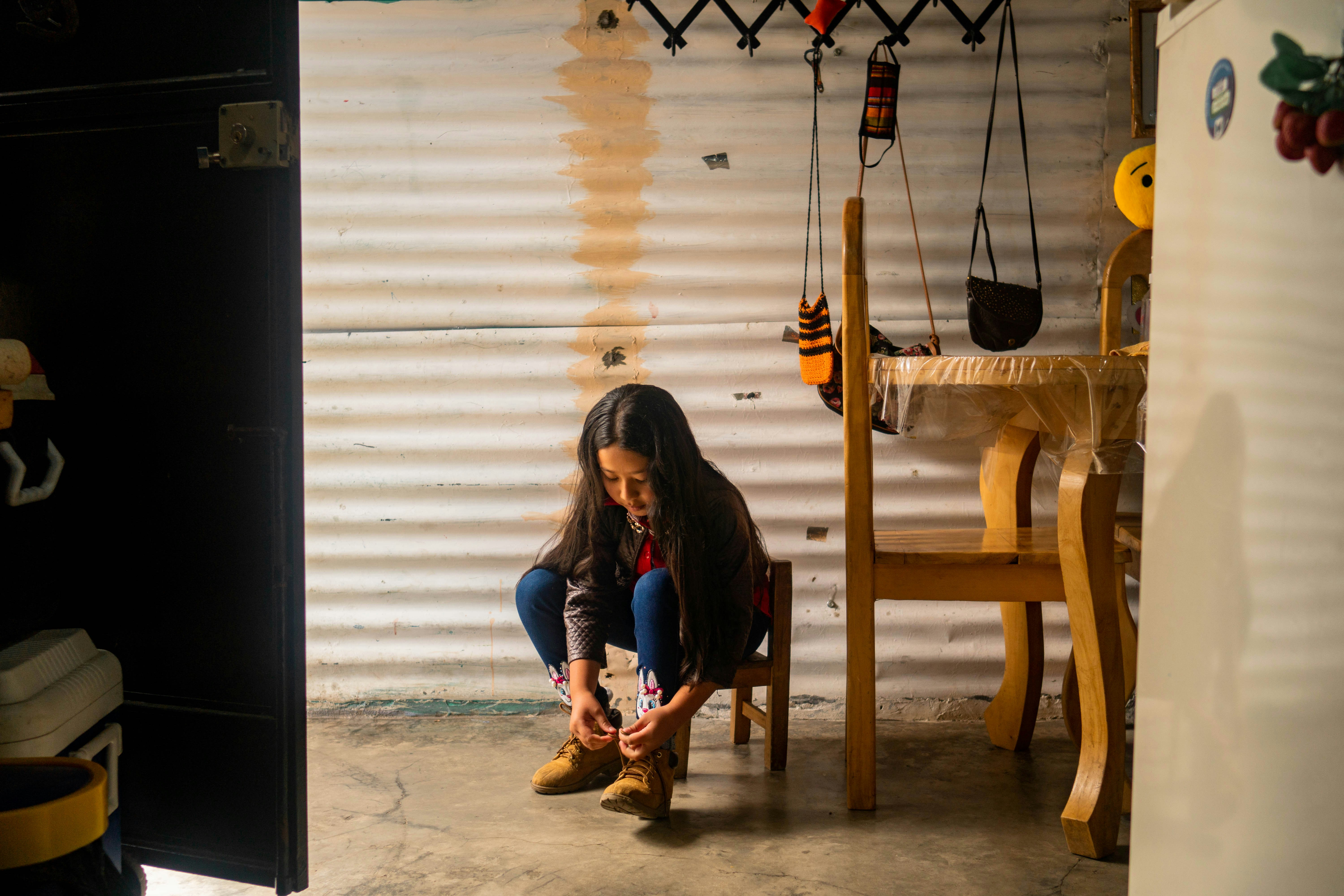A woman sitting on a chair in a garage
