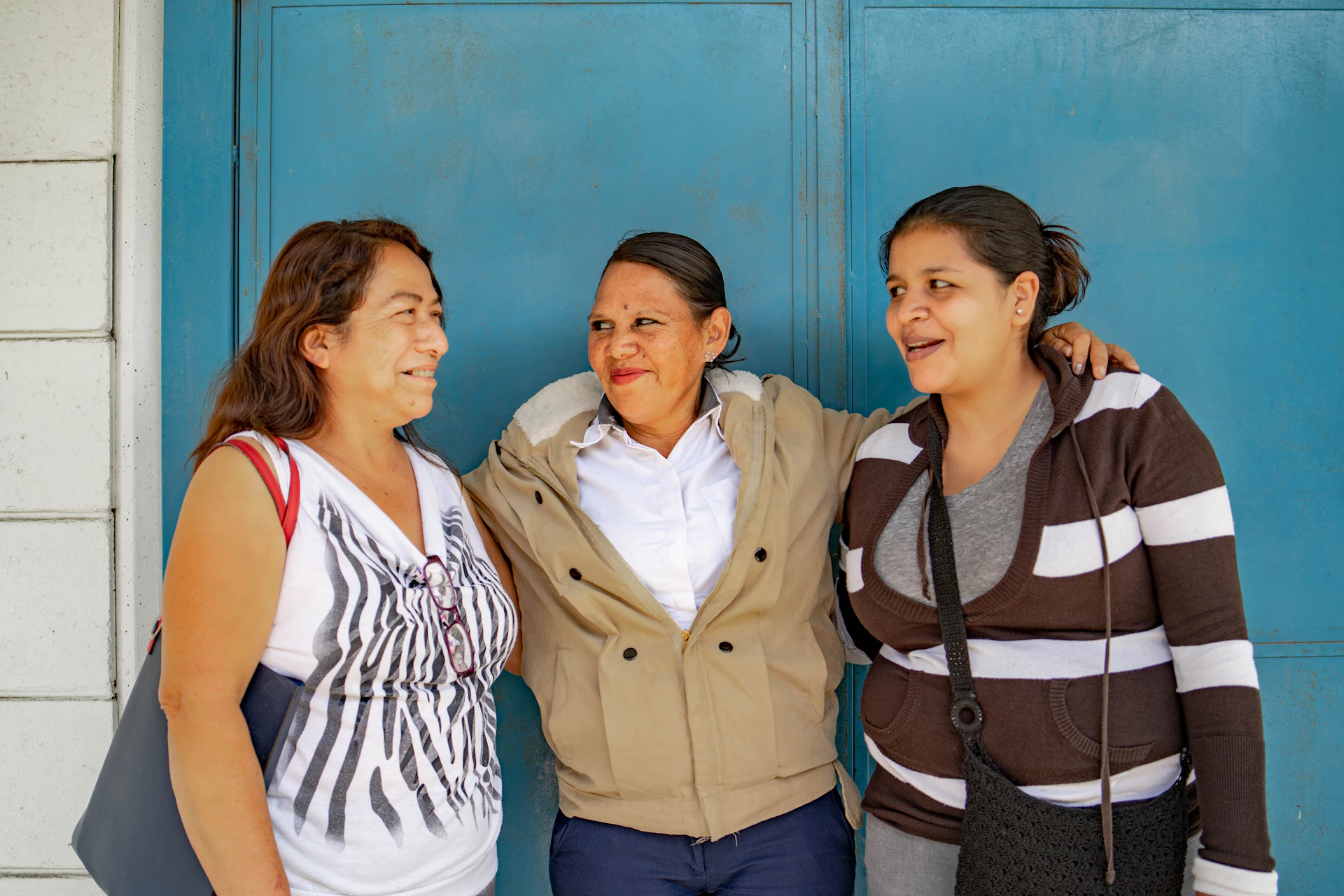A group of three women standing next to each other