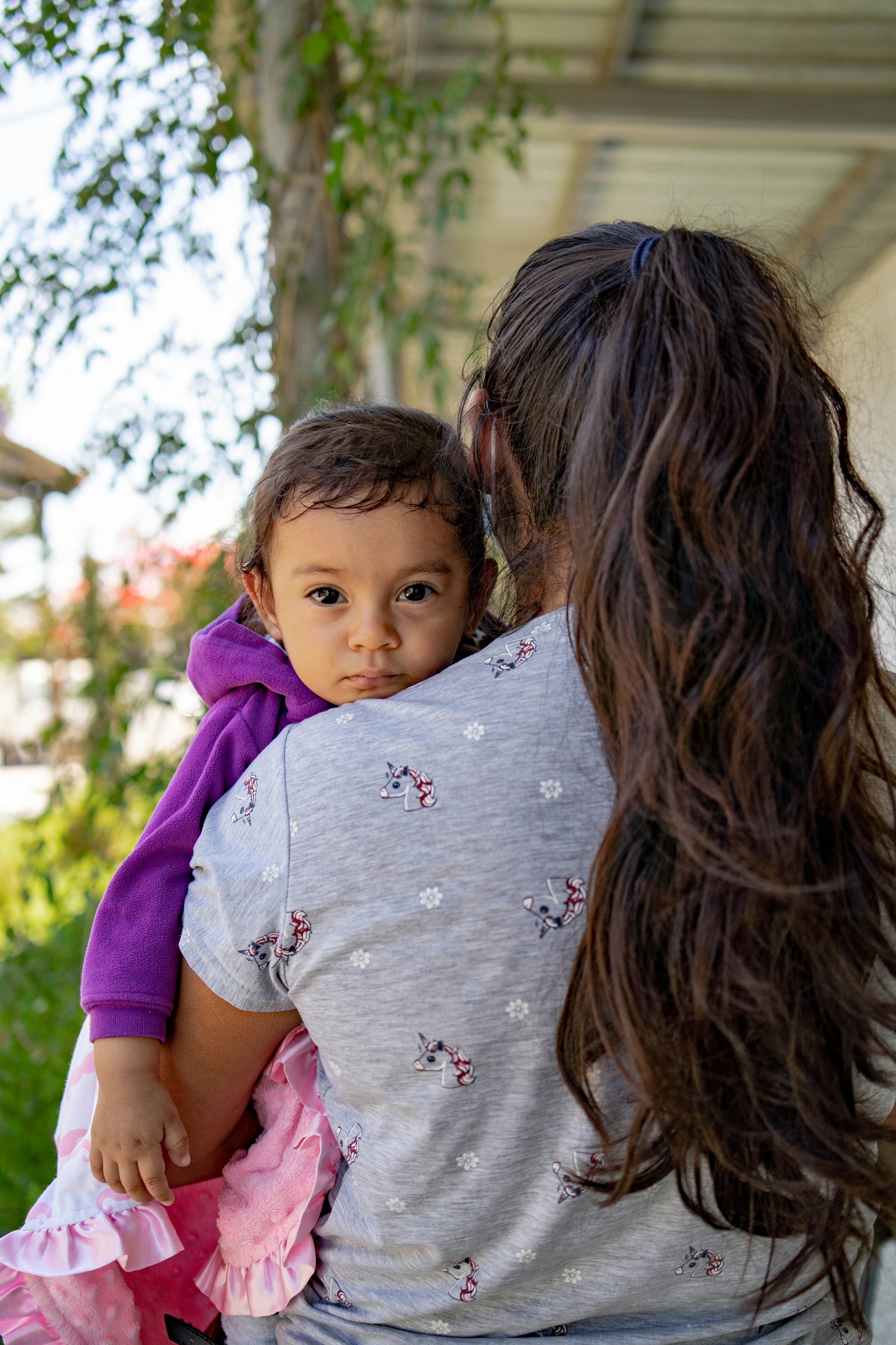 A woman holding a small child in her arms