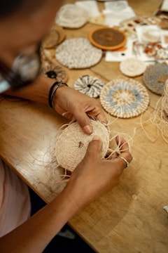 A person working on a piece of art on a table