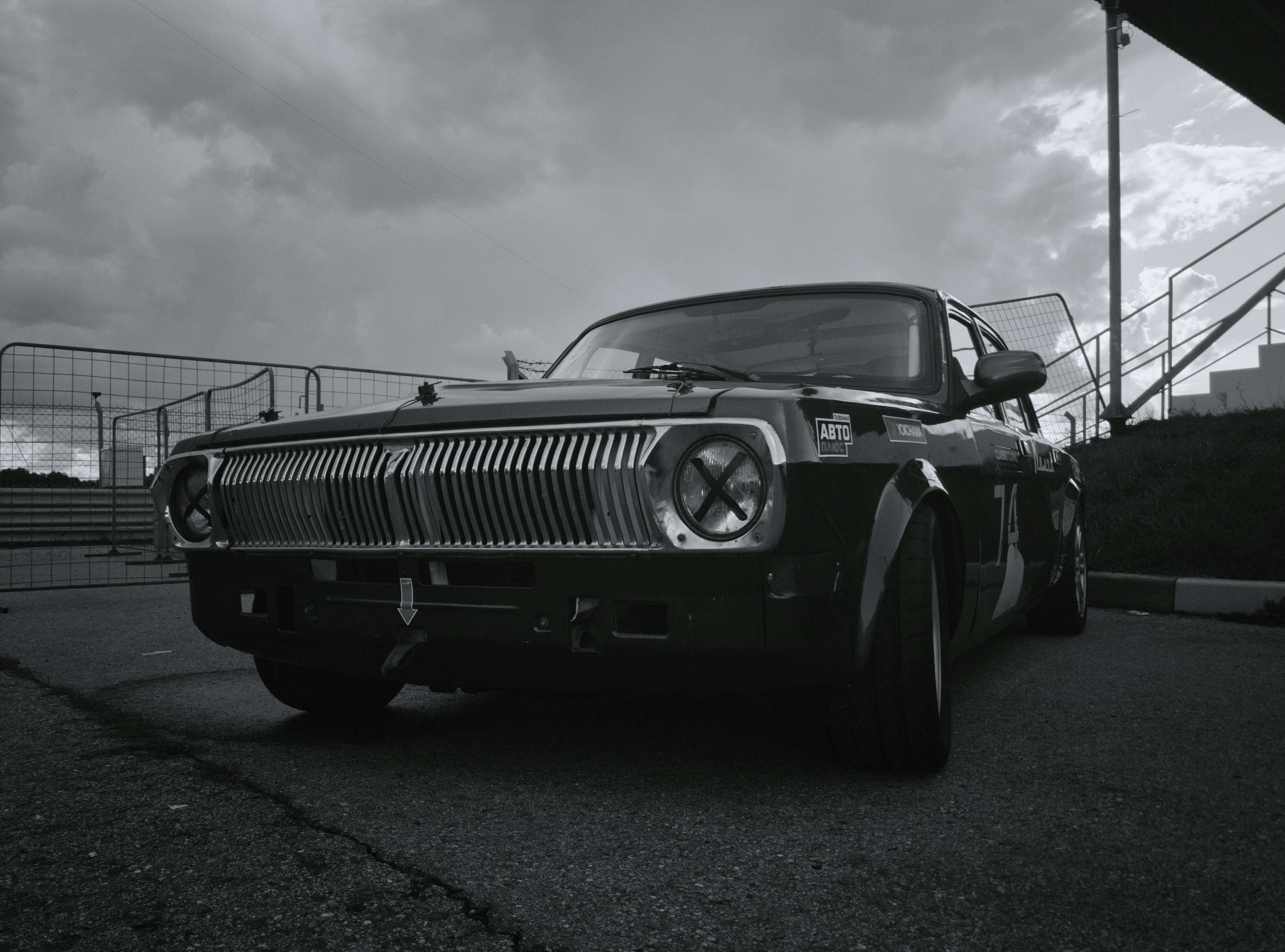 A black and white photo of a classic car