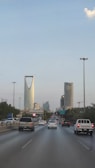 A view of a highway with cars and buildings in the background