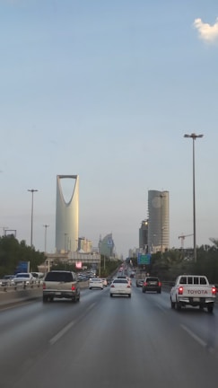 A view of a highway with cars and buildings in the background