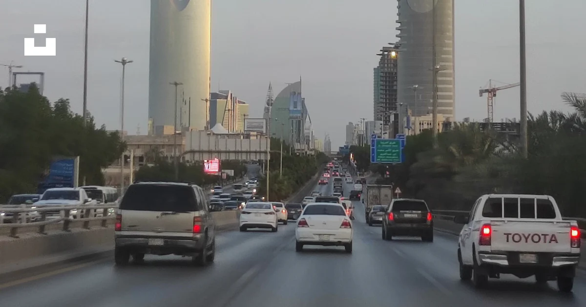 A view of a highway with cars and buildings in the background photo ...