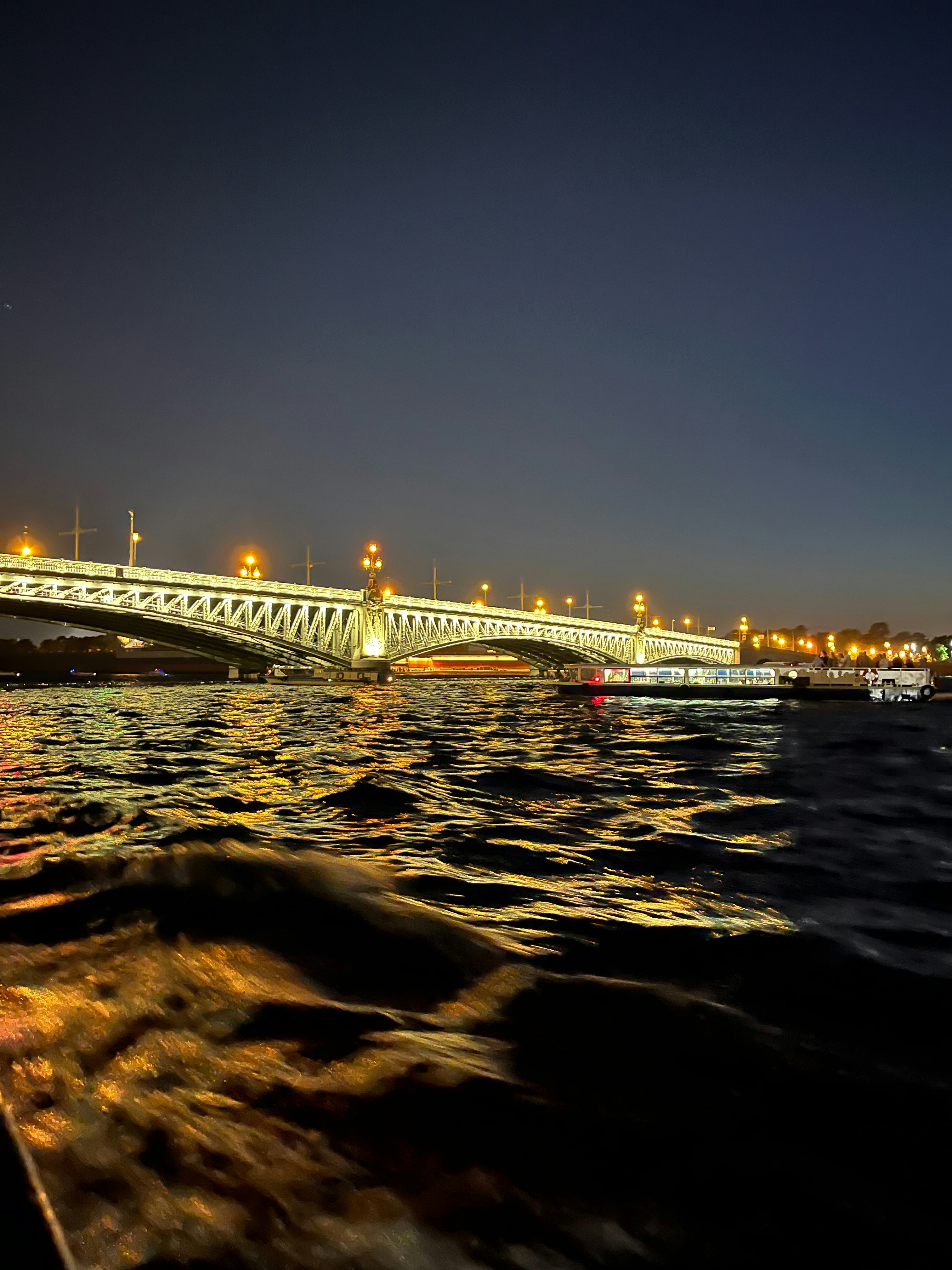 A bridge over a body of water at night