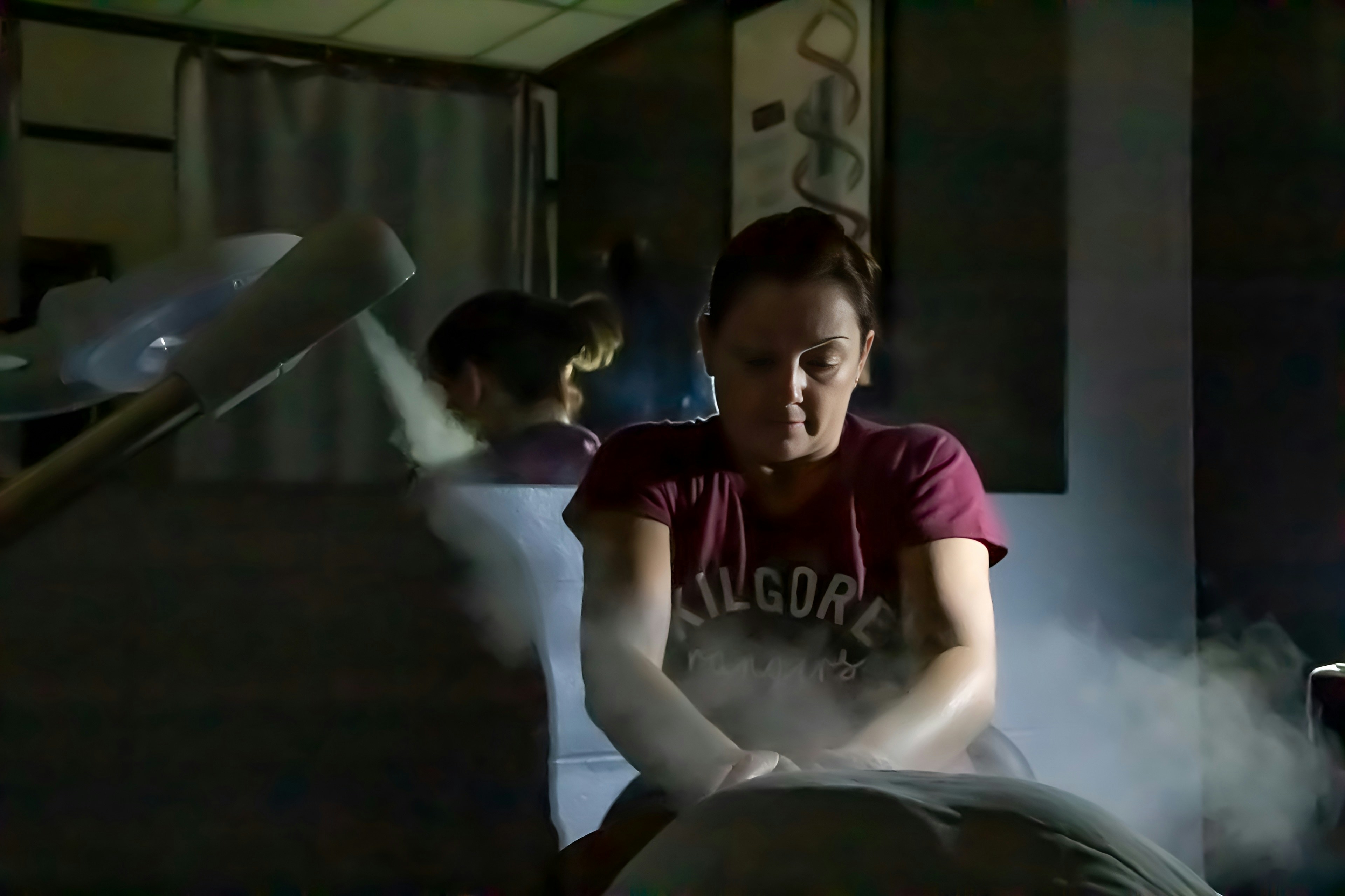 A woman sitting on top of a bed in a room