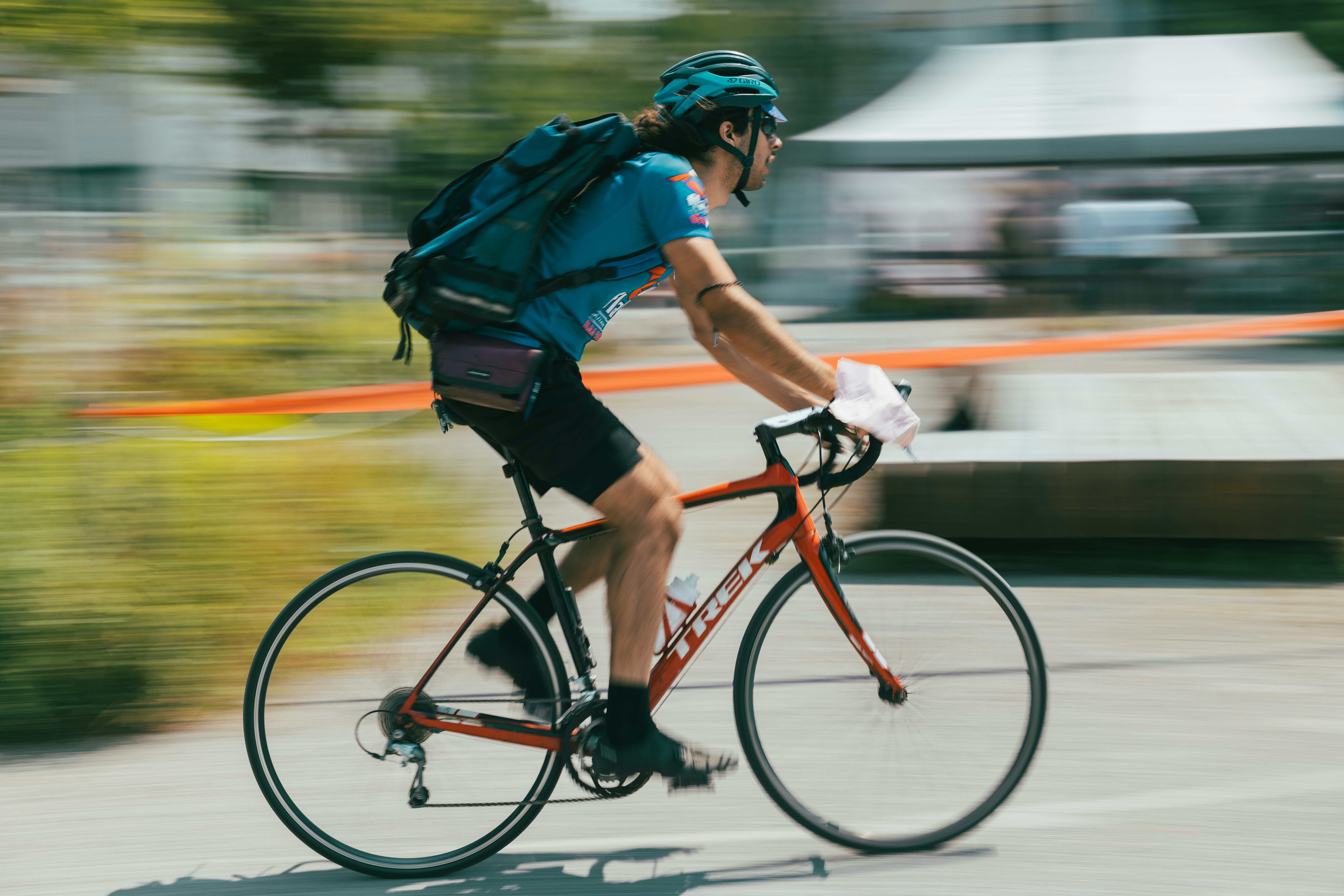 A man riding a bike down a street
