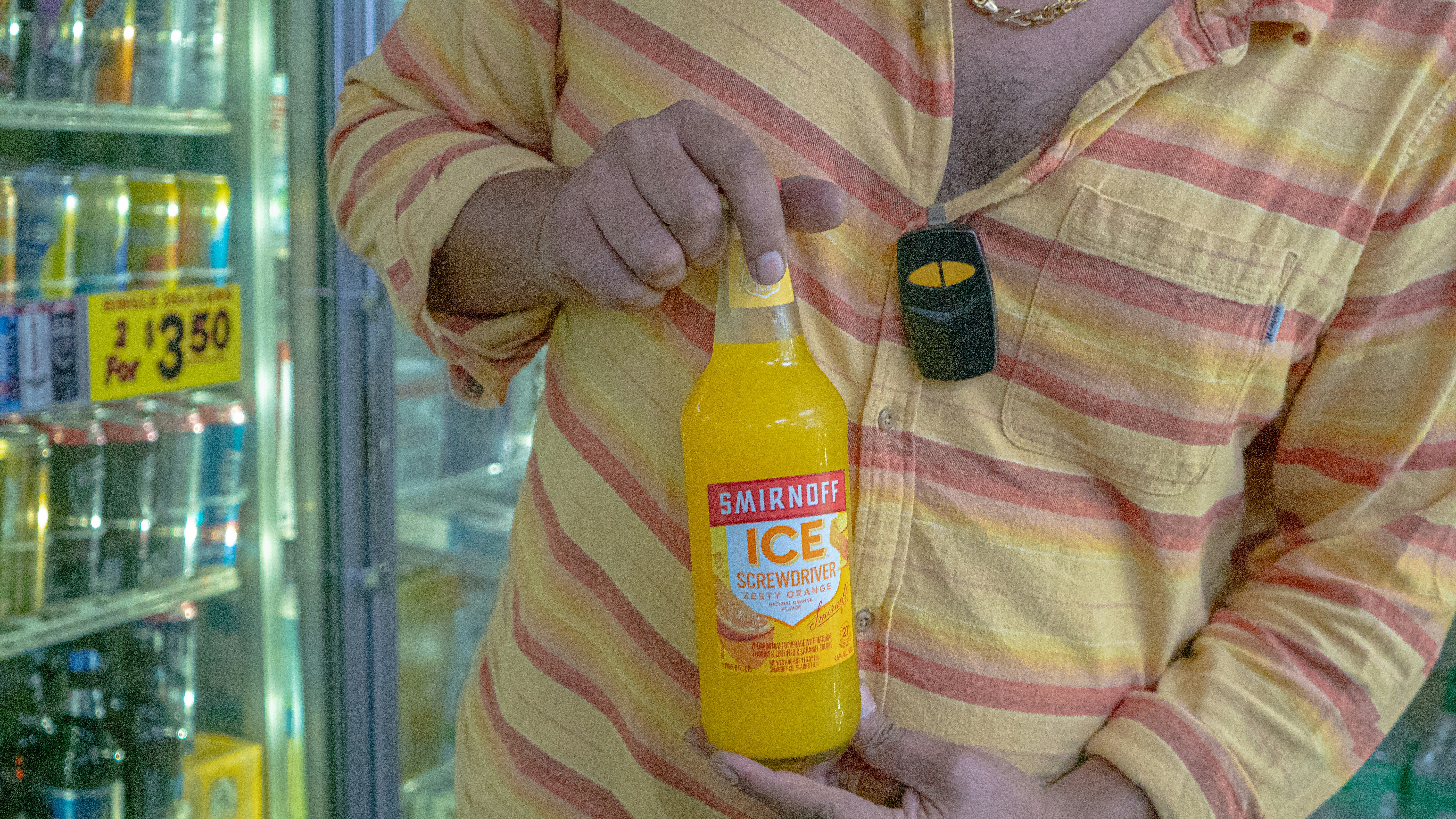 A man holding a bottle of orange juice