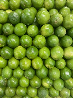 A large pile of limes sitting on top of each other