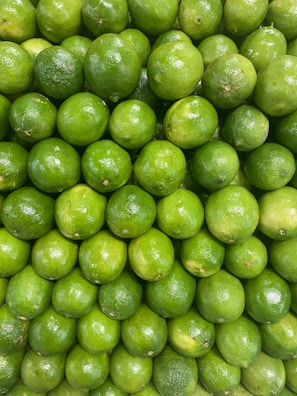 A large pile of limes sitting on top of each other