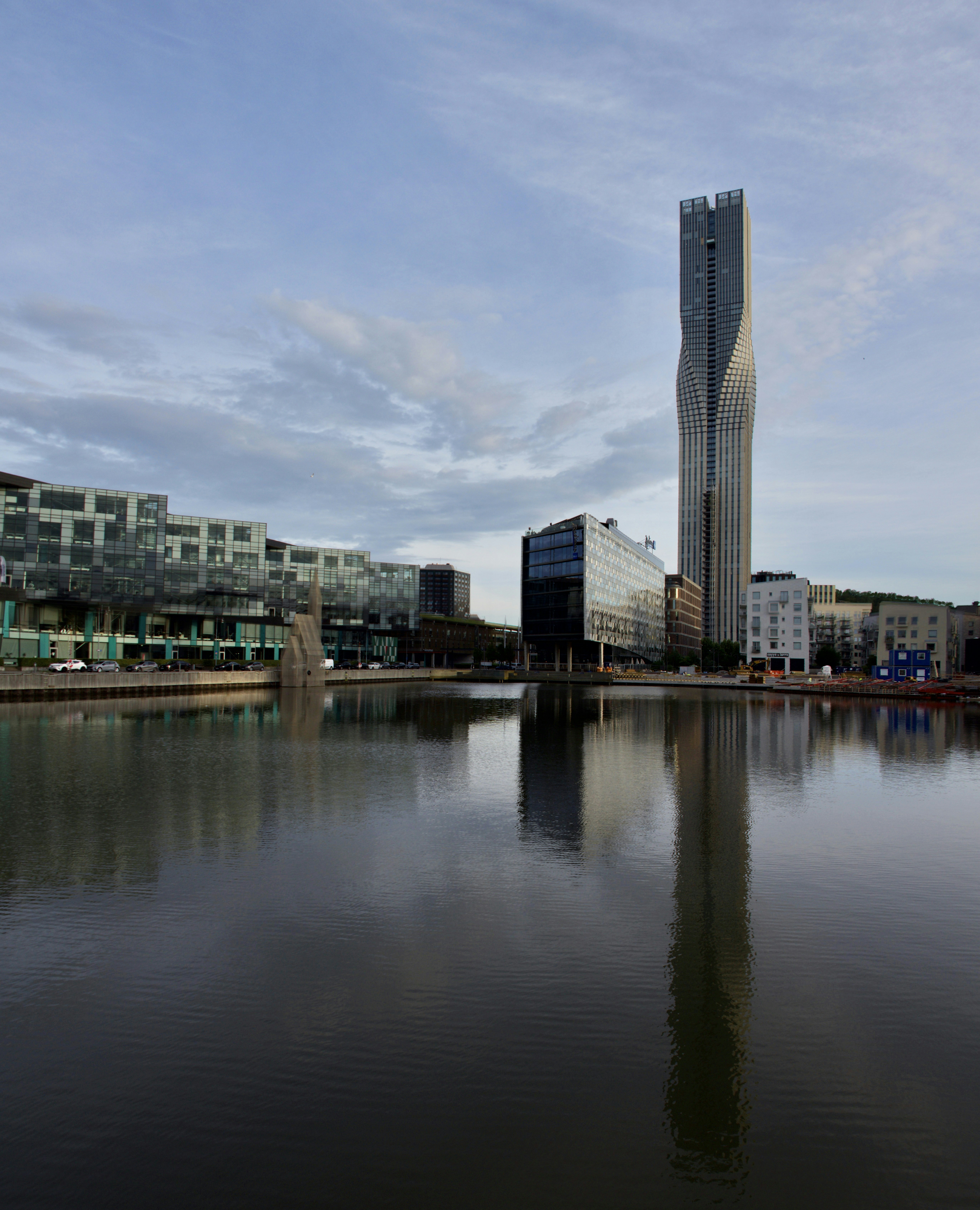 A body of water with buildings in the background