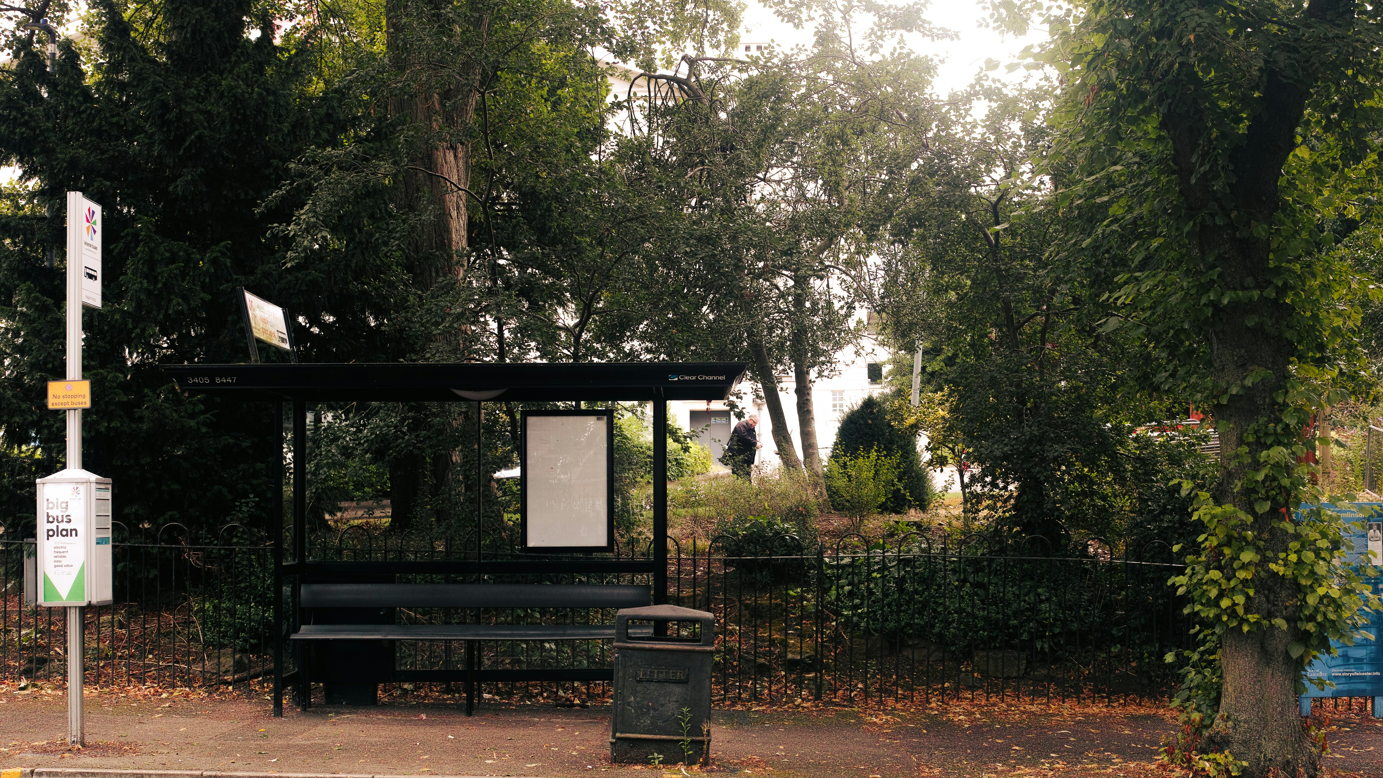 A park bench sitting on the side of a road