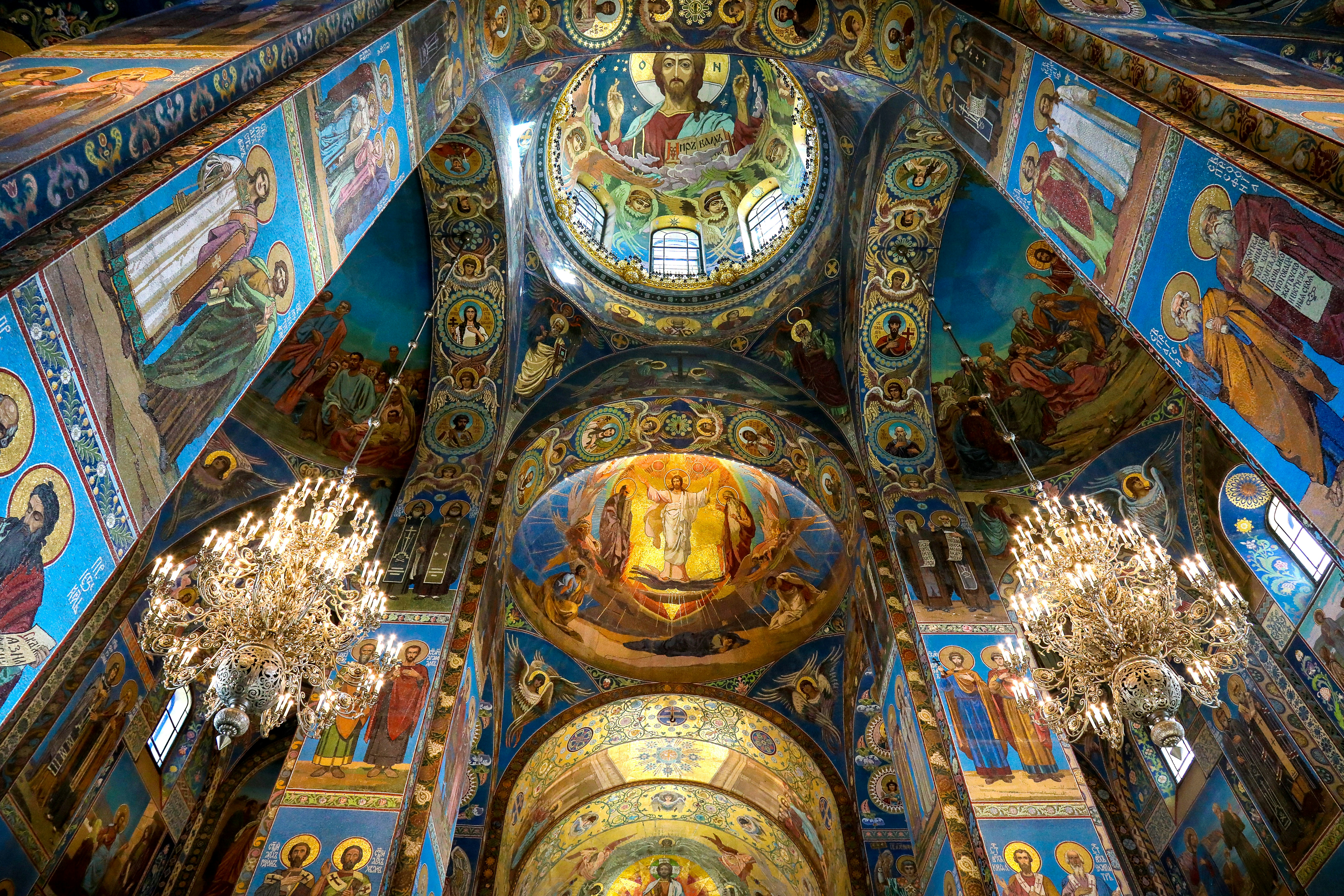 The ceiling of a church with paintings on it