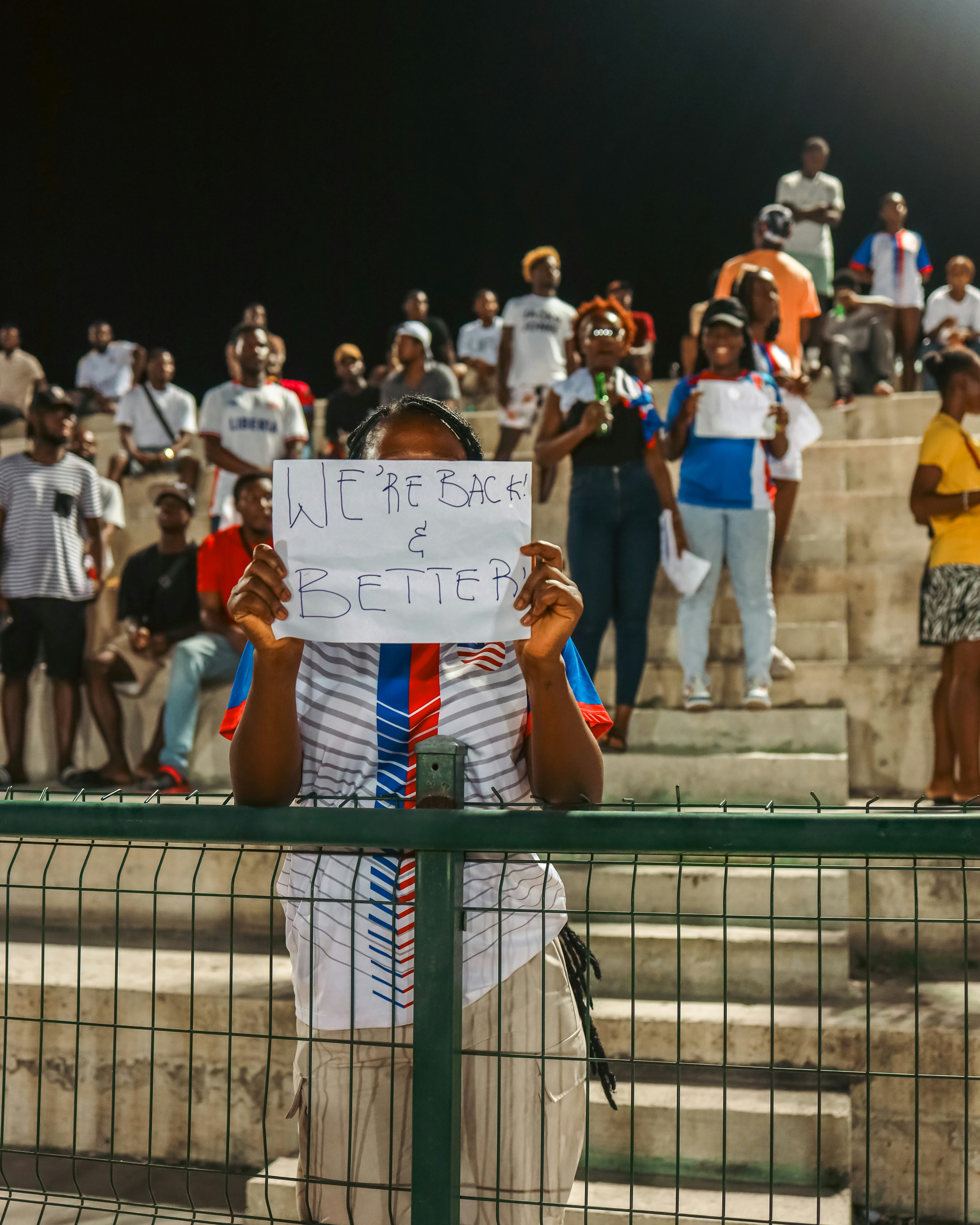 A man holding a sign in front of a crowd of people