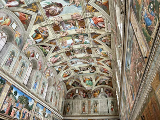 The ceiling of a building with many paintings on it