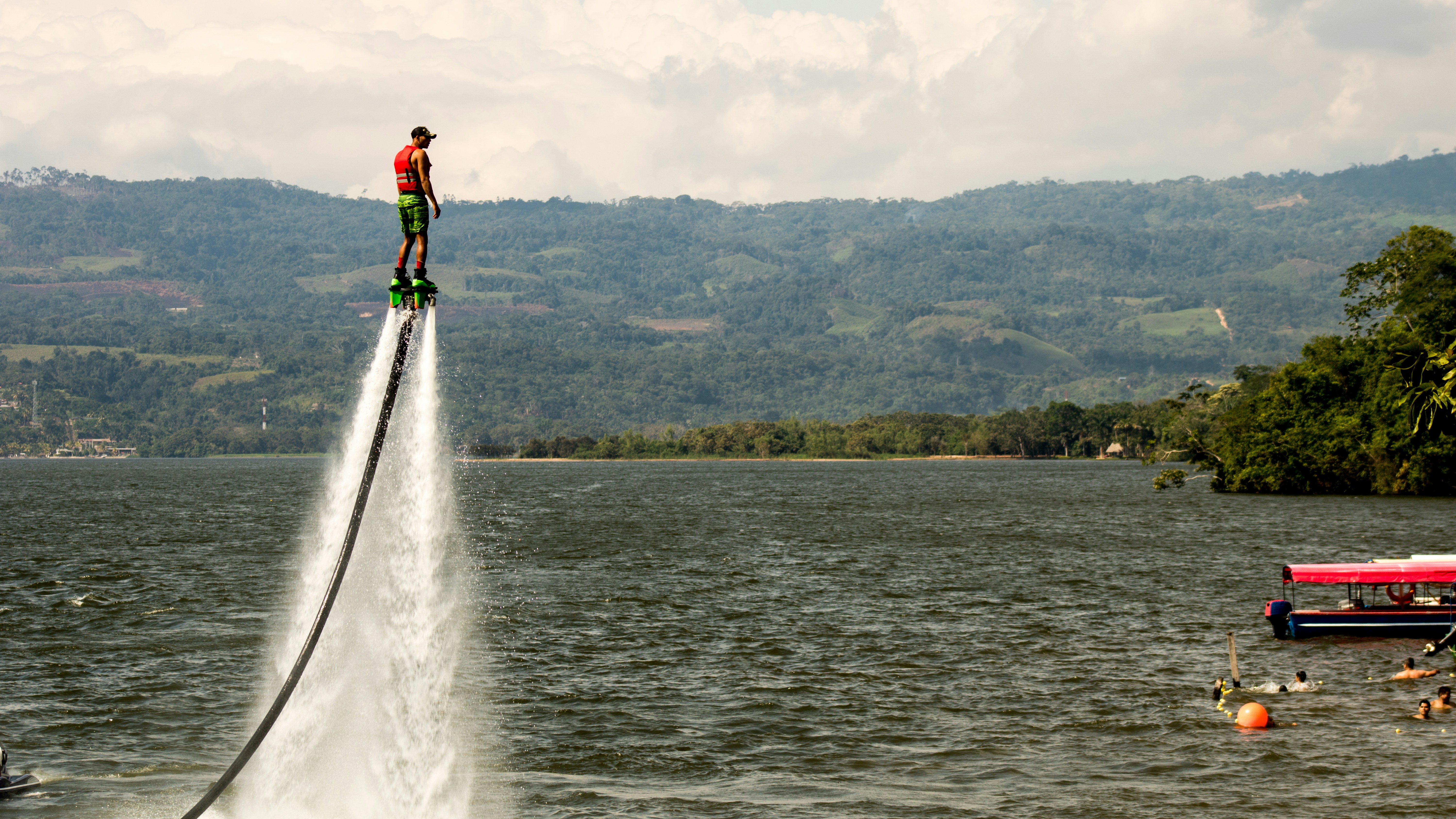 A person on a jet ski being pulled by a boat