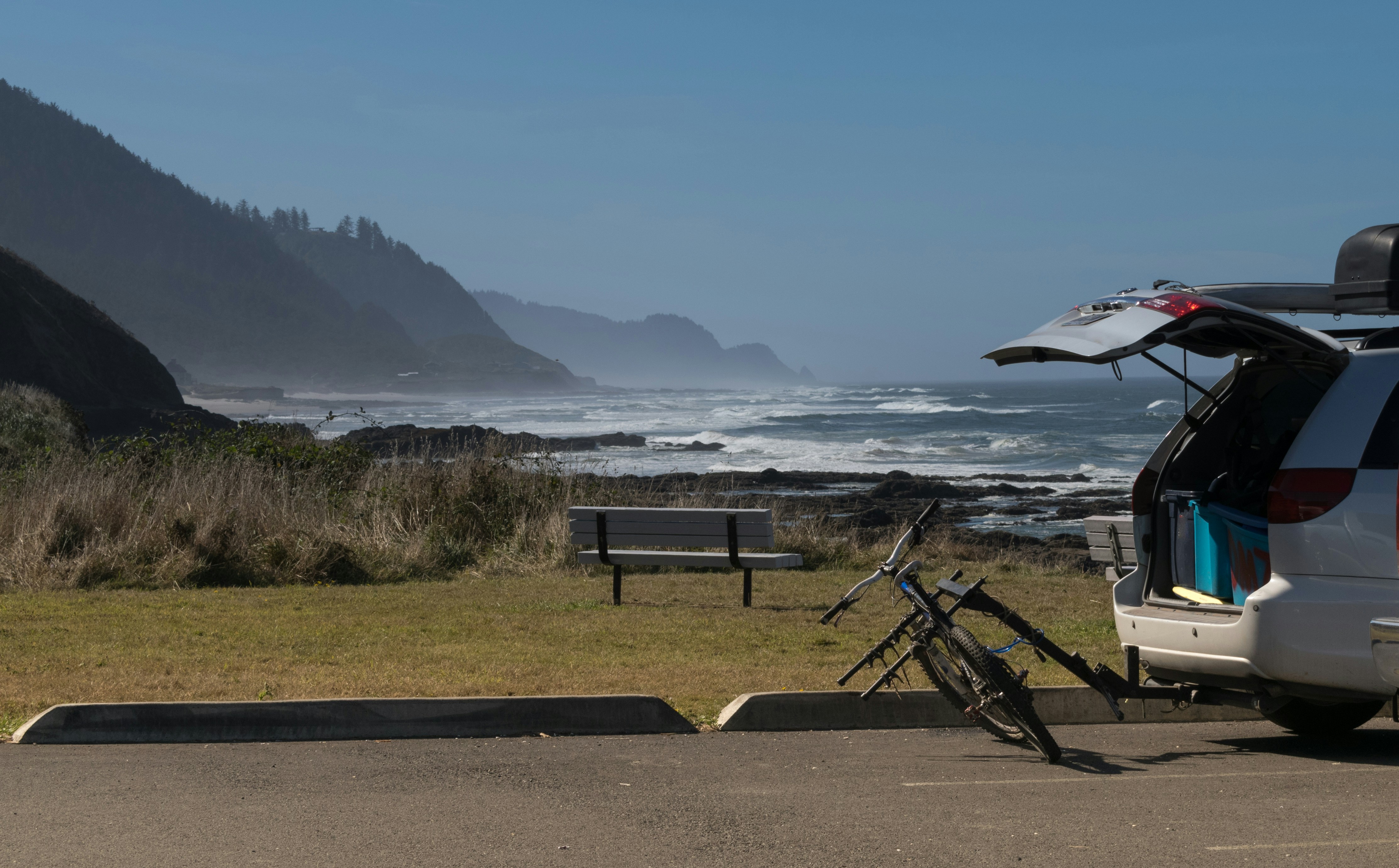 A van parked on the side of a road next to the ocean