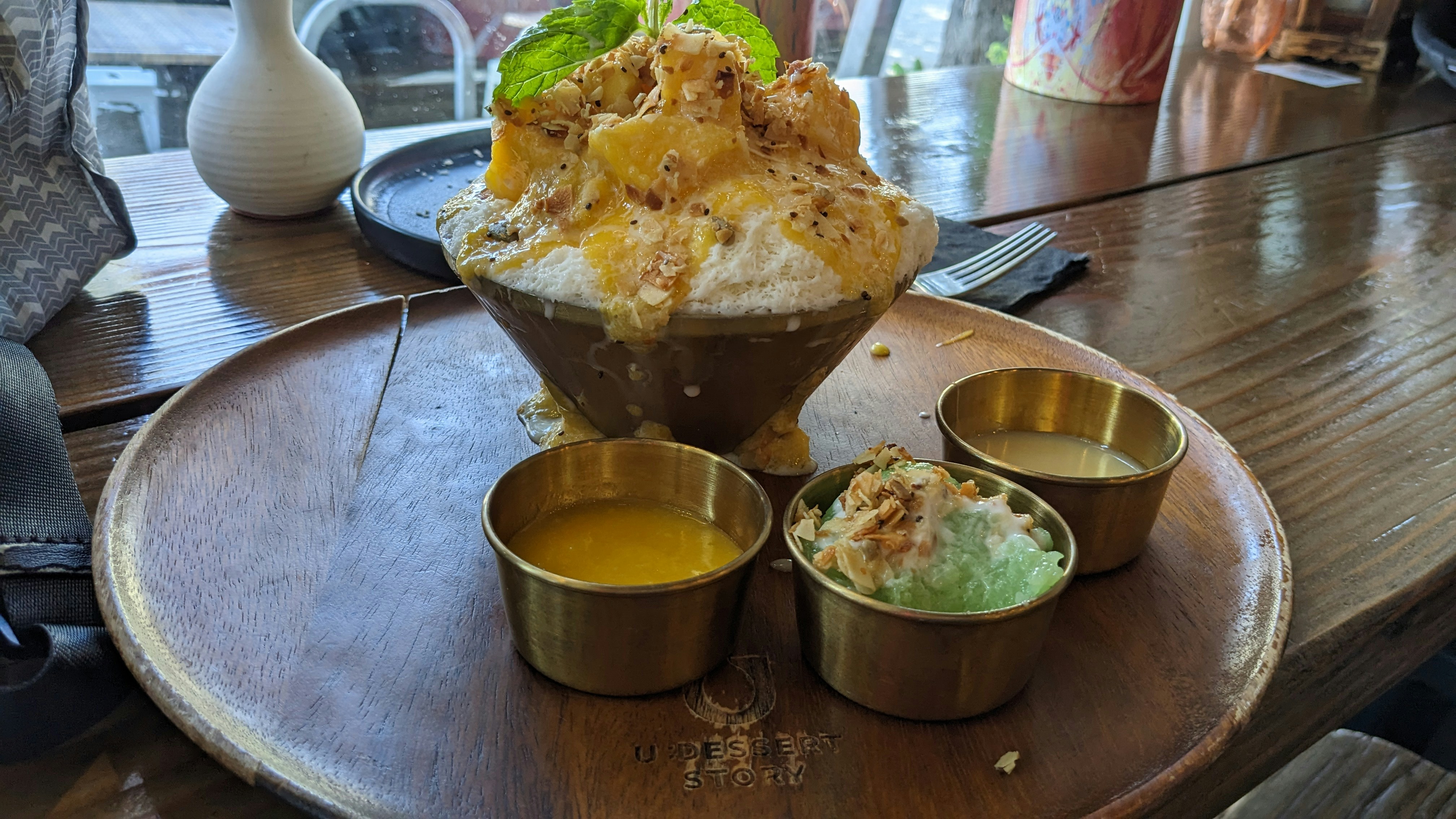 Wooden table with three cups of food