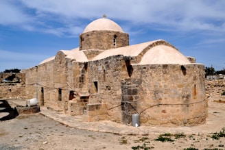 A stone building with a white dome on top of it