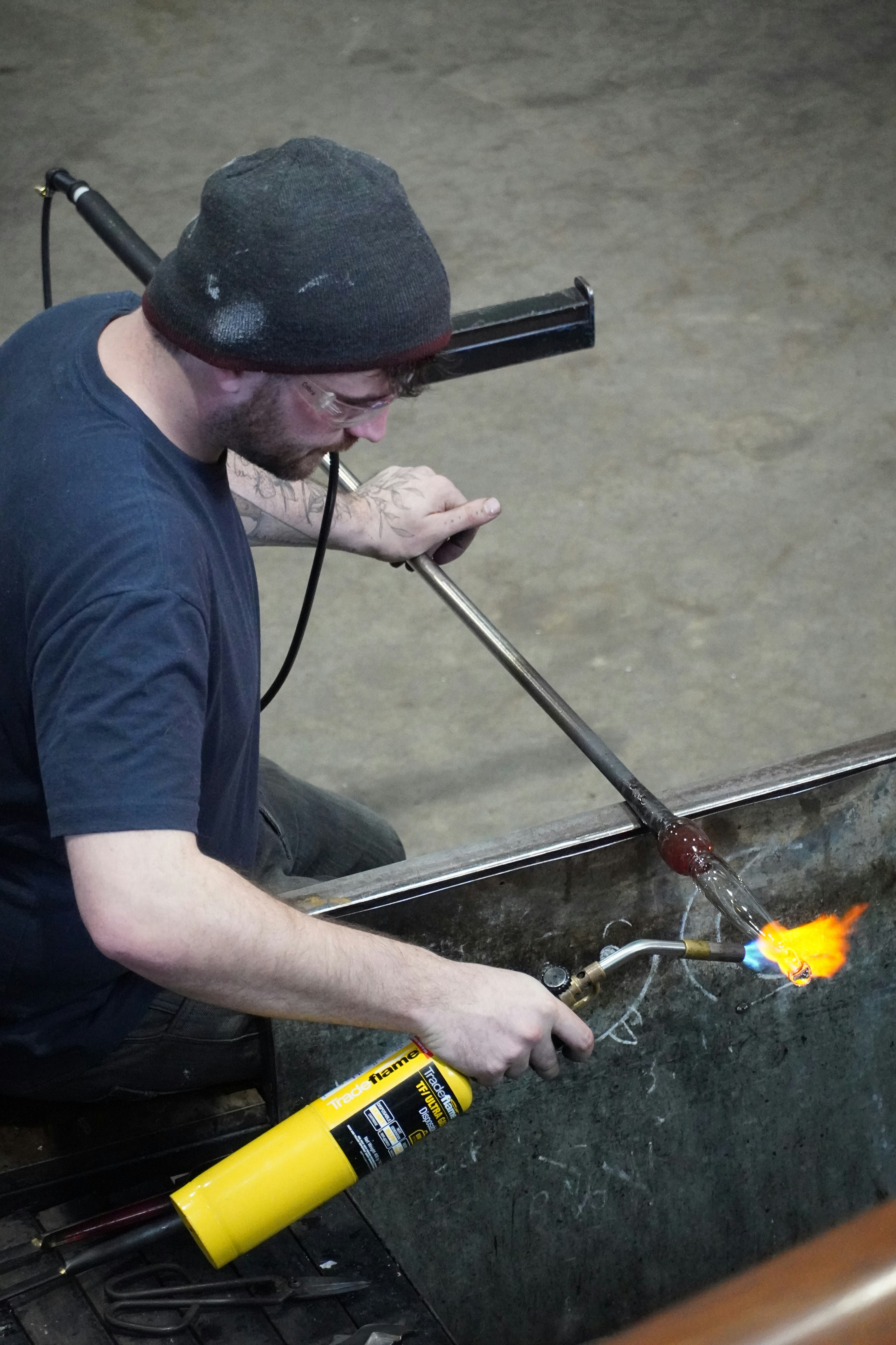 A man is working on a piece of metal