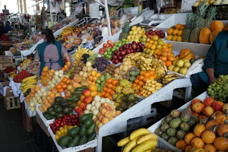 A woman standing in front of a fruit stand
