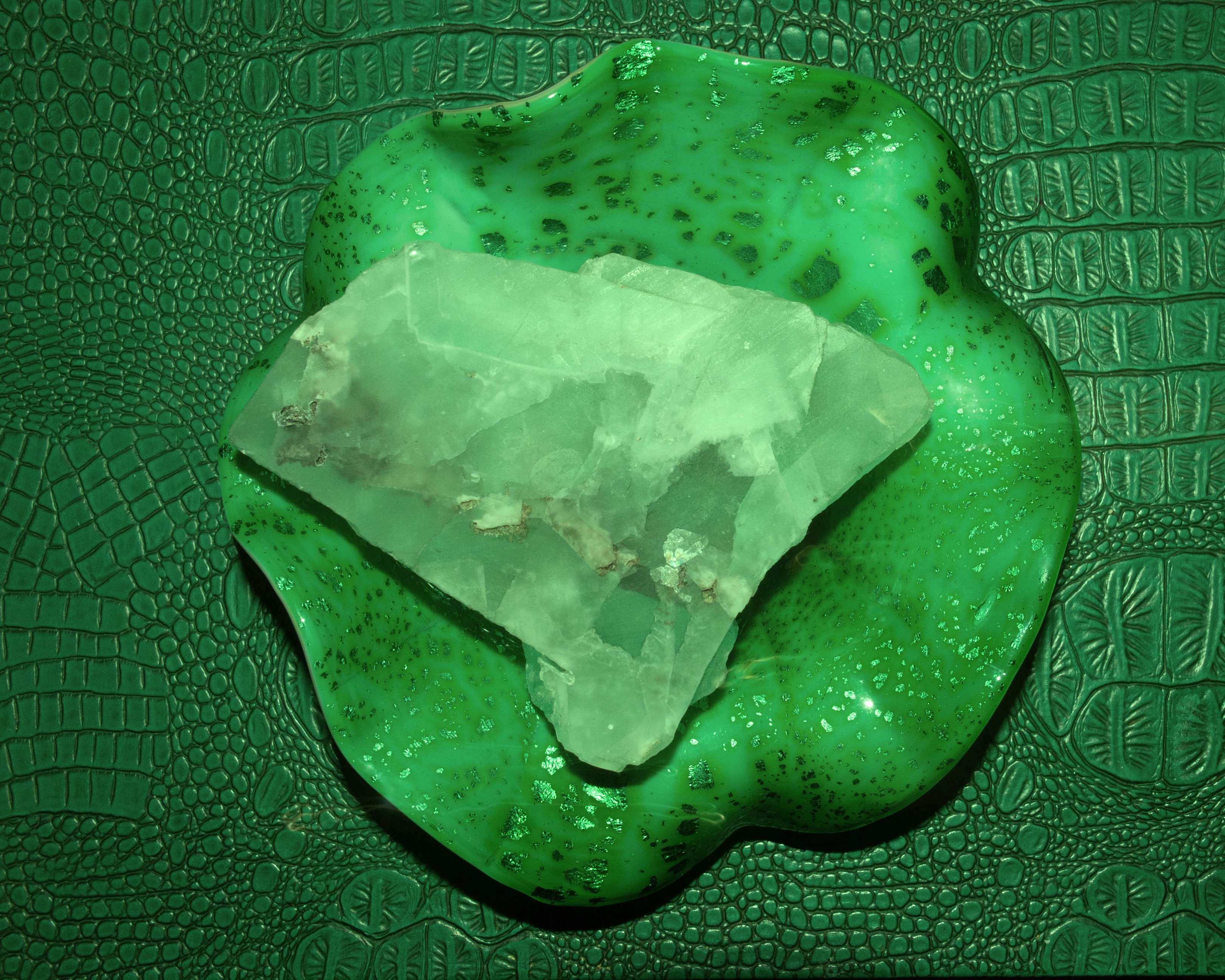 A piece of green material sitting on top of a green surface
