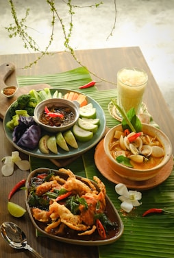 A wooden table topped with plates of food