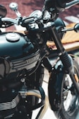 A black motorcycle parked next to a building