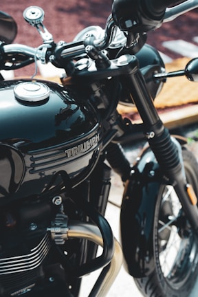 A black motorcycle parked next to a building