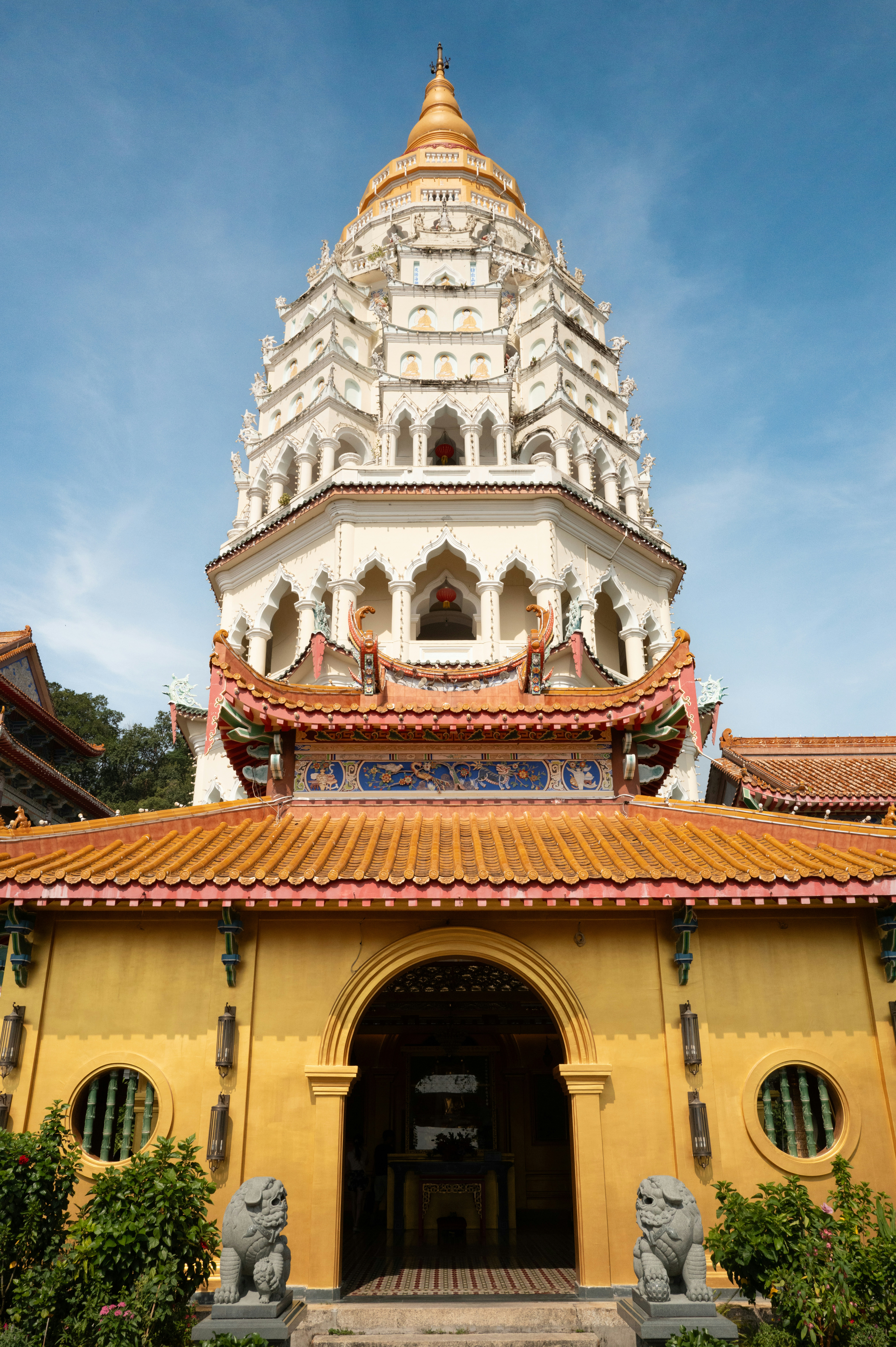 A tall white building with a yellow roof