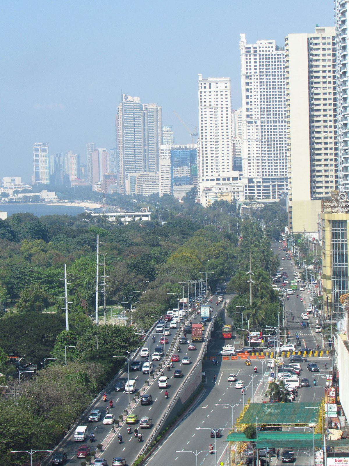 A busy city street with tall buildings on Roxas Boulevard, Manila