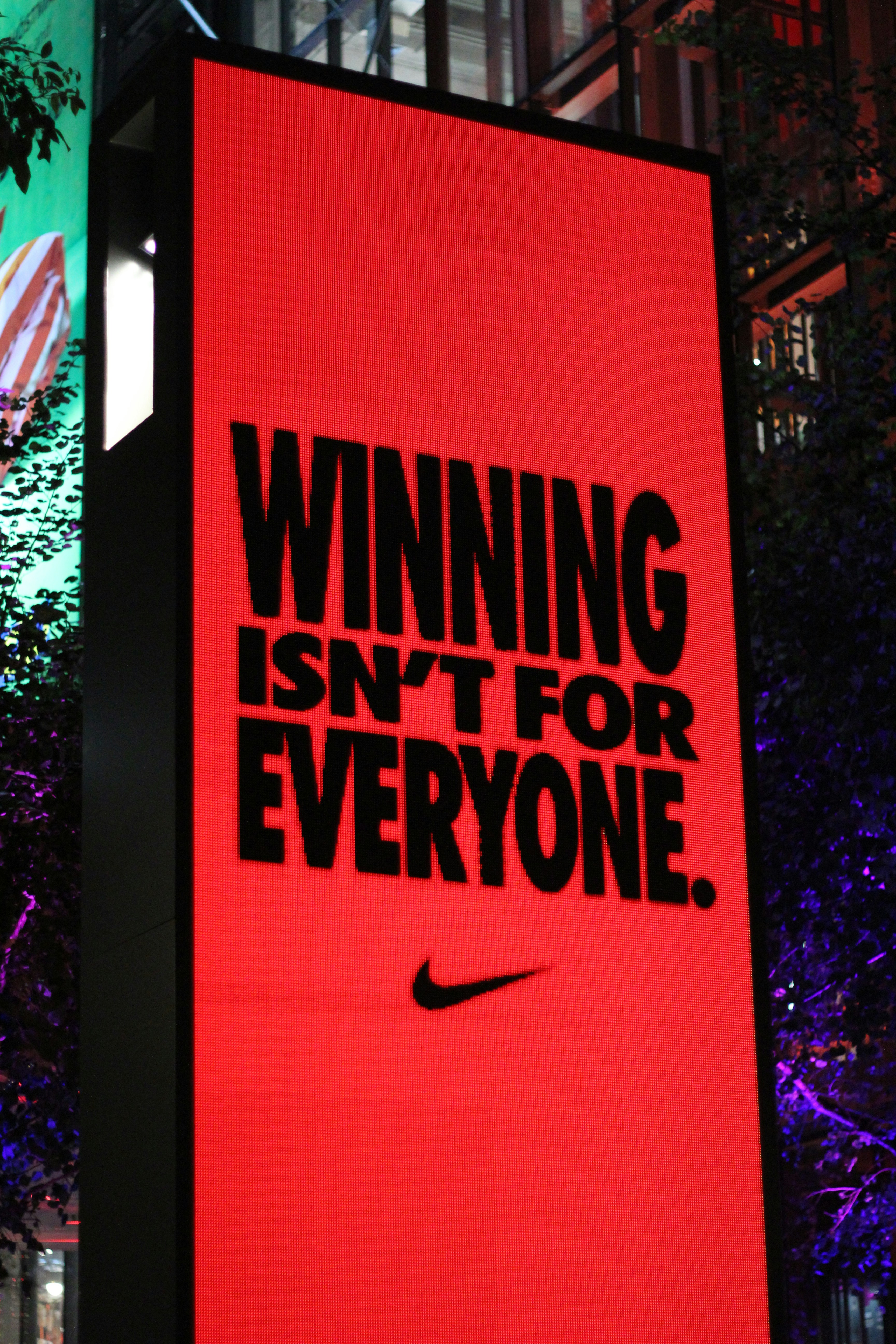 A large red billboard with a nike advertisement on it