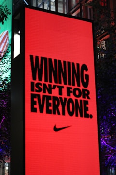 A large red billboard with a nike advertisement on it