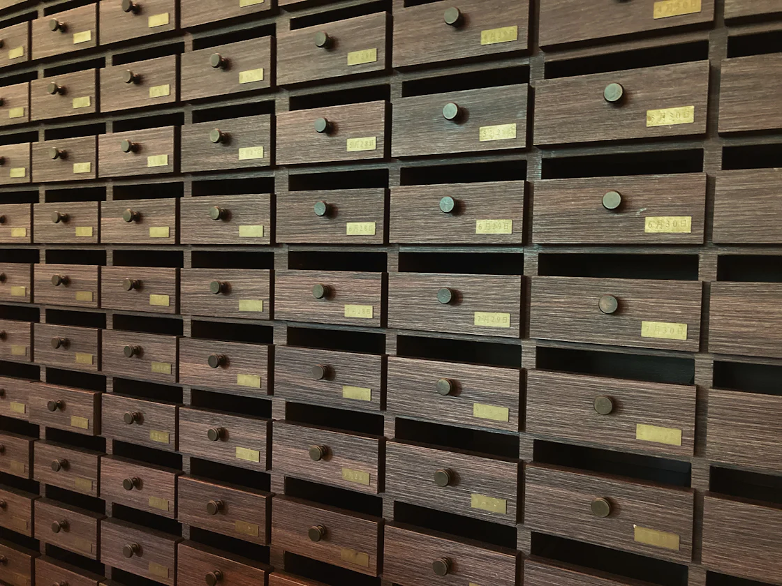 A wall of organized drawers representing file management and the systematic organization that AI agents like Claude Cowork bring to knowledge work.