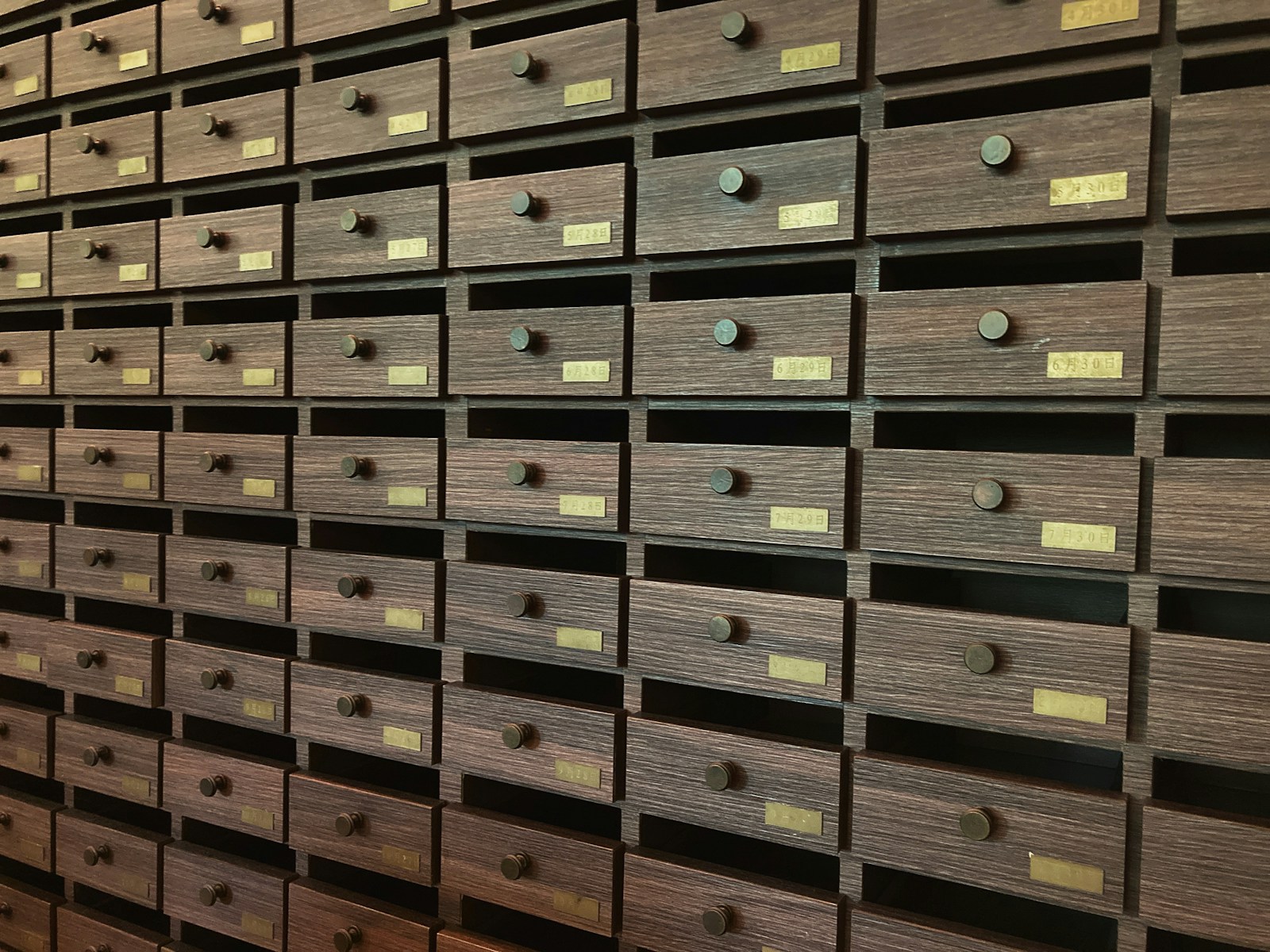 A wall of organized drawers representing file management and the systematic organization that AI agents like Claude Cowork bring to knowledge work.