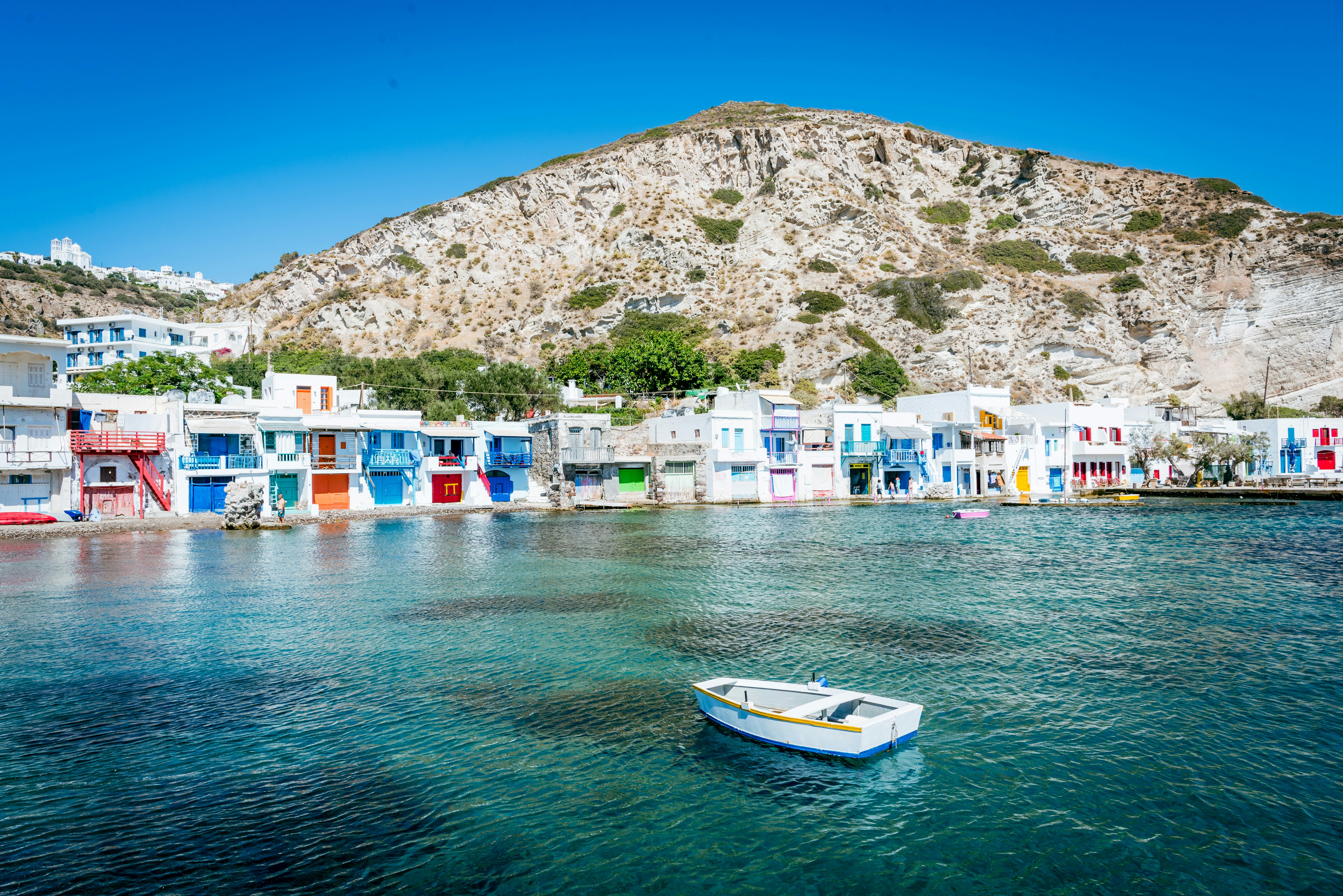 A small boat floating in a body of water