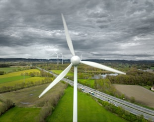 An aerial view of a wind turbine in a rural area