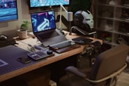 A computer desk with two monitors and a keyboard