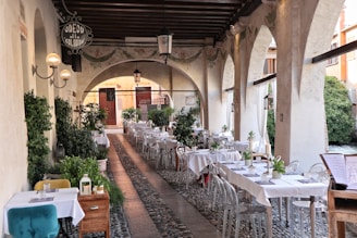 A long table with white tablecloths and chairs