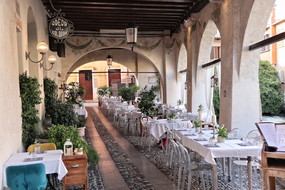 A long table with white tablecloths and chairs