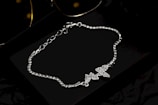 A pair of sunglasses and a chain bracelet