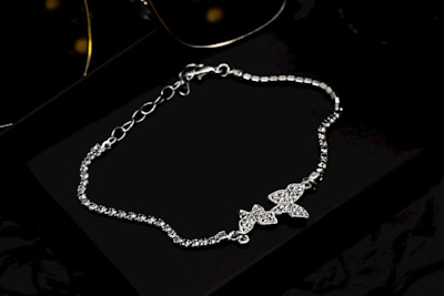 A pair of sunglasses and a chain bracelet