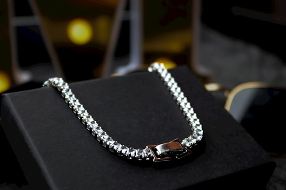 A black box with a silver chain on it