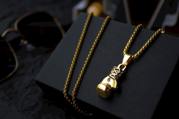 A pair of glasses and a necklace on a black box