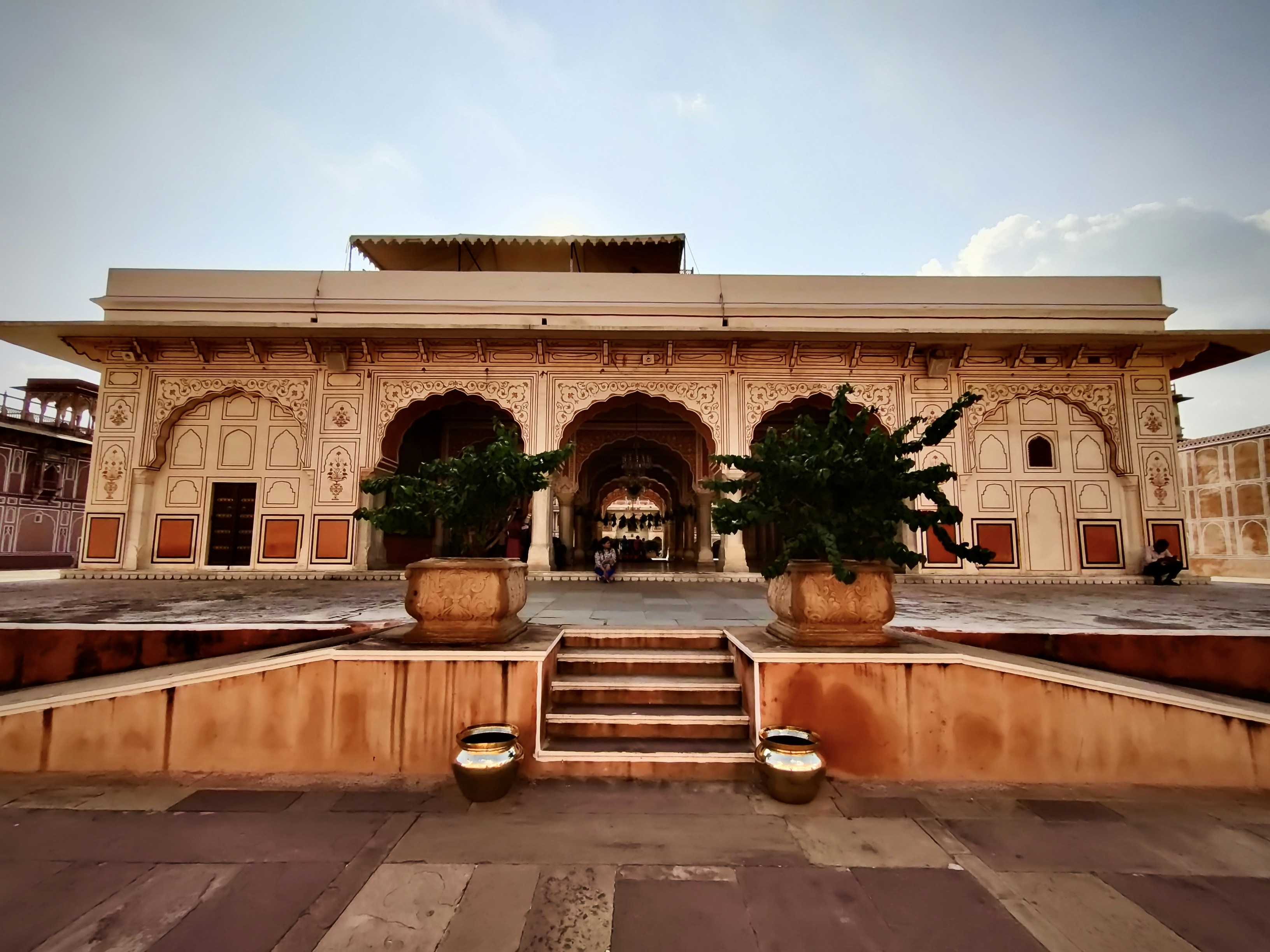 woman wearing yellow long-sleeved dress under white clouds and blue sky during daytime